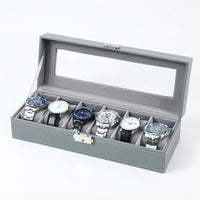 Boîte à Montres 6 Compartiments – Cluny, vue de trois quarts sur fond clair, finition Gris Perle, avec montres